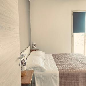 a bedroom with a bed and a window at Etna Rooftop in Trecastagni +46 photos
