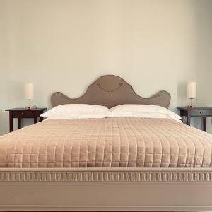 a bedroom with a large white bed with two tables at Etna Rooftop in Trecastagni