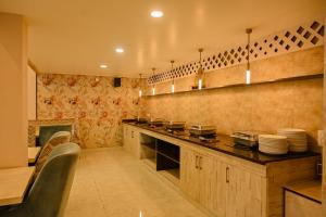 a kitchen with a counter with dishes on it at Hotel Jaisingh Palace in Jaipur