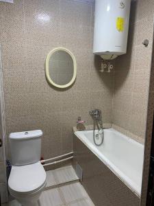 a bathroom with a toilet and a sink and a tub at Samarkand,Uzbekistan in Samarkand