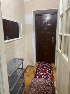a hallway with a door and a rug on the floor at Samarkand,Uzbekistan in Samarkand