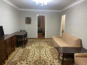 a living room with a couch and a desk at Samarkand,Uzbekistan in Samarkand