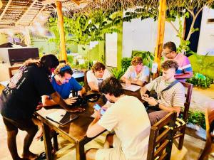 a group of people sitting at a table in a restaurant at Baywatch Arugambay in Arugam Bay +53 photos