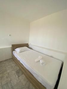 a small room with a bed with a roll of paper on it at Selinia Apartments in Selínia