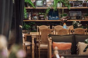 a dining room with a table and chairs and plants at Dali GuGu Hotel in Dali Ancient Town