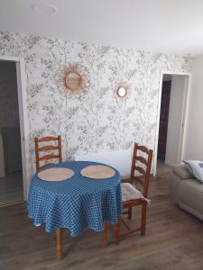 a dining room with a table and two chairs at L'Escale Baie in Pendé +10 photos