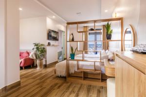 a living room with a bed and a table at AuraLite Hotel - Panorama View Đà Lạt in Da Lat