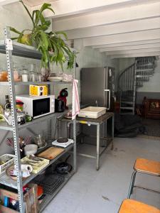 a kitchen with a table and a microwave at L Atelier in Angoulême +10 photos