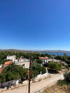 a view of a city from a hill with a street at Selinia Apartments in Selínia +5 photos