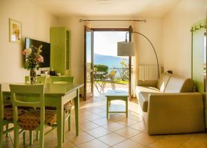 a living room with a table and a couch at Residence Besass, GTSGroup in Tignale