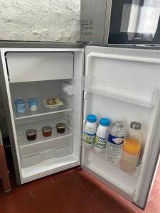 an open refrigerator with drinks and bottles of water at La Maisonnette in Cellettes
