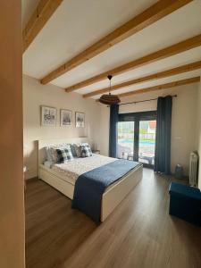 a bedroom with a bed and a large window at Casa do Alambique in Alvaredo +22 photos