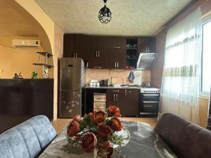 a kitchen with a table with two dolls on it at Davitis Vila in Chakvi