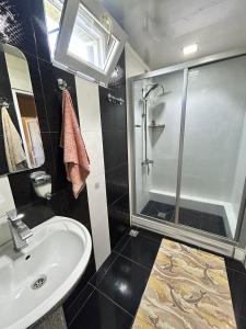 a bathroom with a sink and a shower at Davitis Vila in Chakvi +6 photos