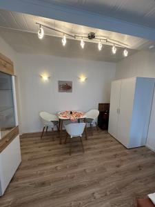 a room with a table and chairs and lights at Relax in the Harz in Hasselfelde