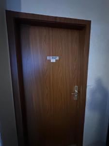 a wooden door with a sign on it at Relax in the Harz in Hasselfelde
