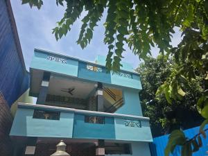 a blue building with writing on it at Fantasy Homestay in Thiruchendur