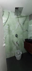 a bathroom with a glass shower with a toilet at Hyton Grand - Kilambakkam in Urapakkam