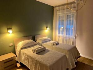 a bedroom with two beds and a window at Le Lenze in Pozzilli