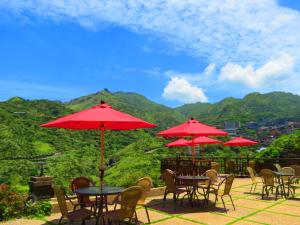 a group of tables and chairs with red umbrellas at Formosa Arcadian Villa in Jiufen