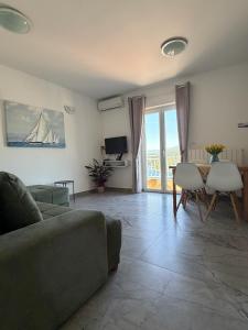 a living room with a couch and a table at Nela Apartment in Rabac