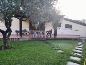a house with a table and chairs in a yard at Casa Francesca in Costa Rei +23 photos