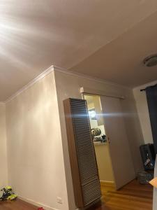 a room with a wall with a door and a mirror at Al amin in Bell Post Hill