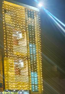 a tall building with lights on the side of it at Shri Krishnam Guest House Near Khatu Mandir in Khātu