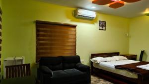 a bedroom with a bed and a couch at SPATHODEA in Vagamon +90 photos