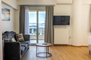 a living room with a couch and a table at Pelagos Suites in Igoumenitsa
