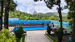 a large swimming pool with a blue backdrop at SPATHODEA in Vagamon