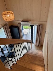 a wooden staircase in a room with a window at Die Tinys - Ferienhäuser am Attersee in Nussdorf am Attersee
