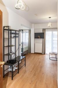 a large living room with a table and a bed at Pelagos Suites in Igoumenitsa