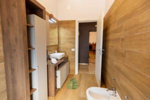 a bathroom with a sink and a toilet in it at Sweet Nonna Dora Corato - Casa con Parcheggio in Corato +37 photos