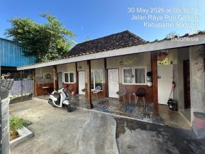 a house with a scooter parked in front of it at Homestay IDR Bali in Jimbaran