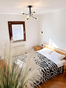 a bedroom with a bed and a window at SPLENDID Sunset Penthouse in Rafailovici