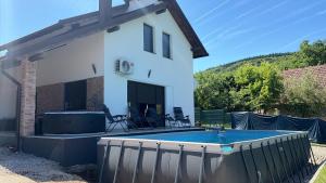 a house with a swimming pool in the yard at Lux apartmani in Bihać +9 photos