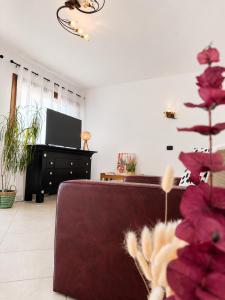 a living room with a couch and a piano at SPLENDID Sunset Penthouse in Rafailovici