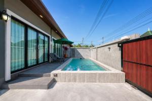 a swimming pool on the side of a house at Arterra Haven , Aonang Krabi in Ao Nang Beach