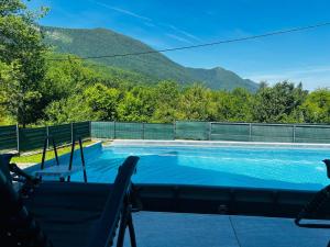 a swimming pool with a view of a mountain at Lux apartmani in Bihać