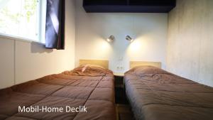two beds sitting next to each other in a room at Camping de l'Ill in Mulhouse