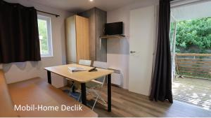 a small room with a desk and a window at Camping de l'Ill in Mulhouse