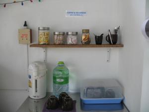a kitchen with a counter top with a shelf at Thai Dee Garden Resort in Haad Rin