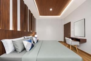 a bedroom with a large bed and a tv at Arterra Haven , Aonang Krabi in Ao Nang Beach