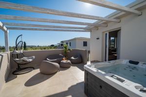 a hot tub on the balcony of a house at Luxury SPA Villa Cefalù in Campofelice di Roccella