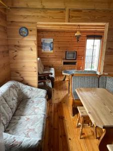 a log cabin with a table and a dining room at Затишок in Svityazʼ