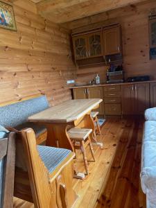 a kitchen with a table and chairs in a cabin at Затишок in Svityazʼ +5 photos