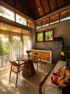 a kitchen with a table and chairs in a room at LUV-Balian in Balian