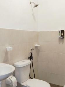 a bathroom with a white toilet and a sink at 25 Homestay Pulai in Johor Bahru +16 photos