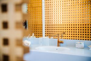 a sink in a bathroom with a mirror and a window at Hôtel Restaurant Auprès d'Angèle in Marcillac-Vallon +53 photos